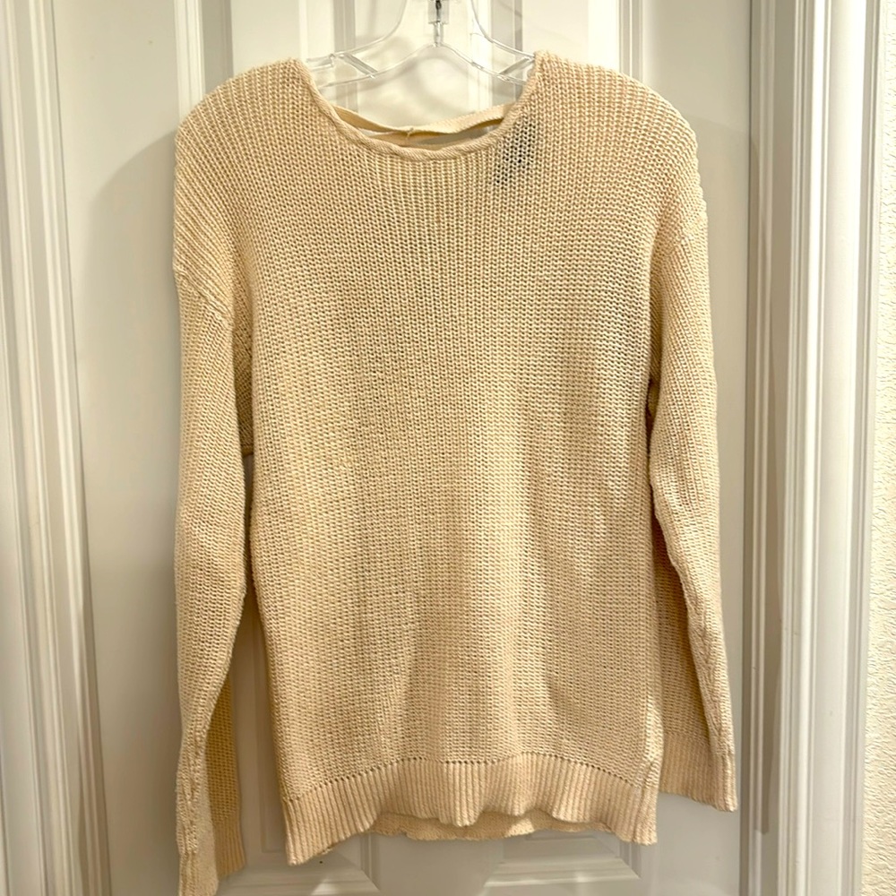 Cream color sweater with back fun detail. Size L
